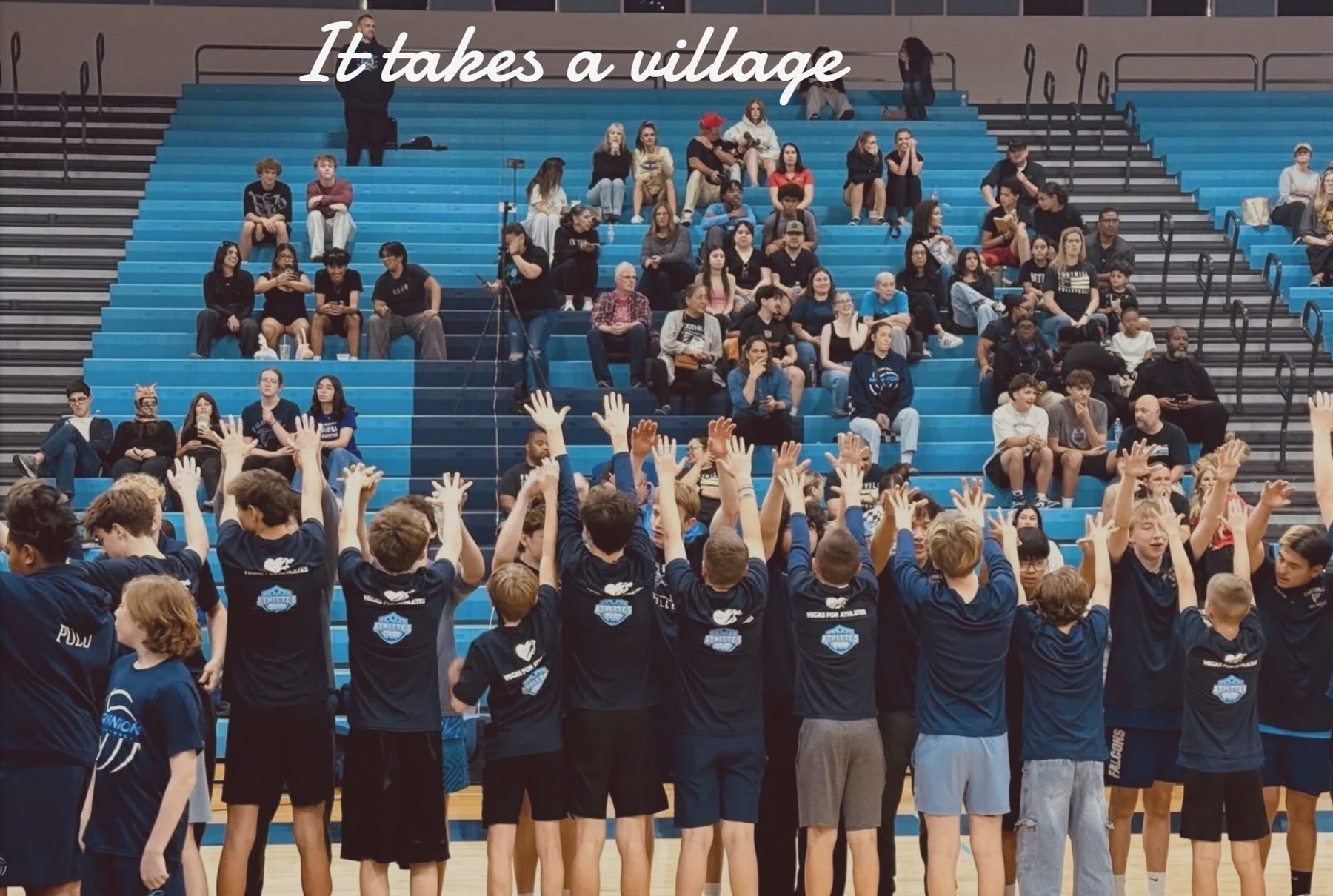 Athlete's Village participants and supporters gathered in a gym